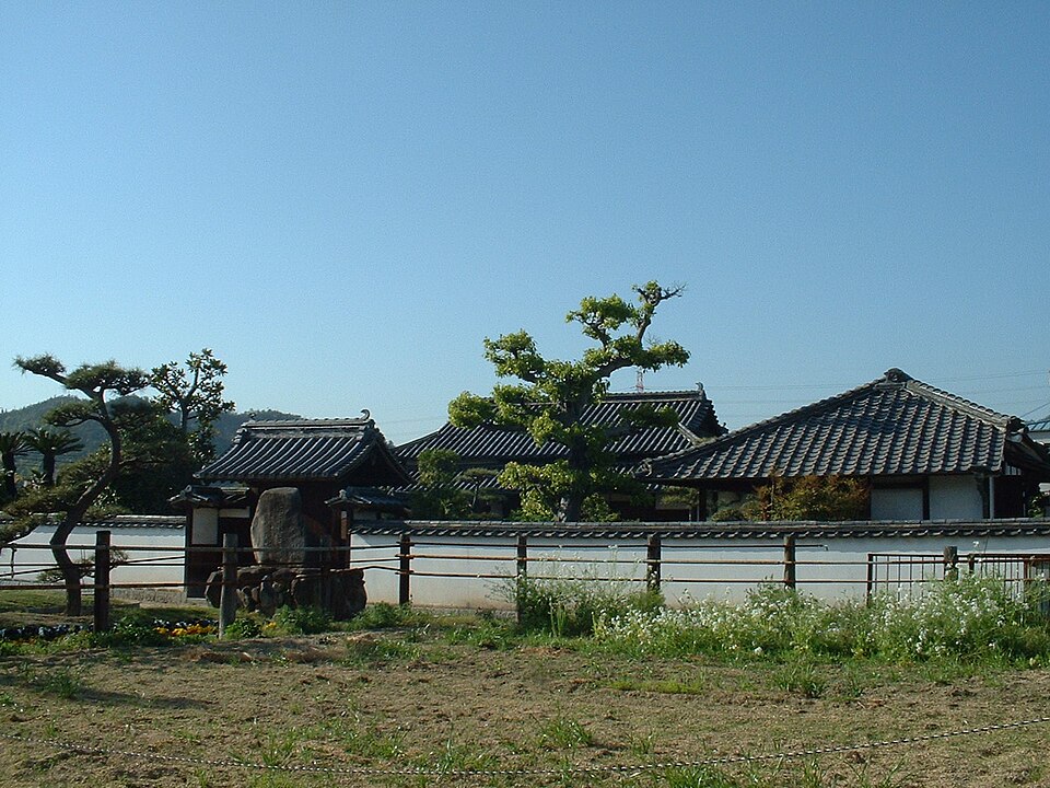 瓦屋根と白い塀に囲まれた仁科芳雄博士生家の外観